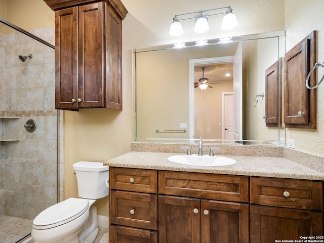 bathroom with vanity, ceiling fan, toilet, and an enclosed shower