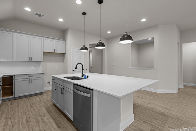 kitchen with sink, tasteful backsplash, dishwasher, an island with sink, and pendant lighting