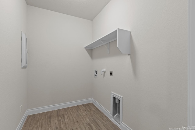 clothes washing area featuring washer hookup, wood-type flooring, hookup for an electric dryer, and gas dryer hookup