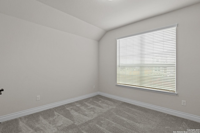 empty room with lofted ceiling and light carpet