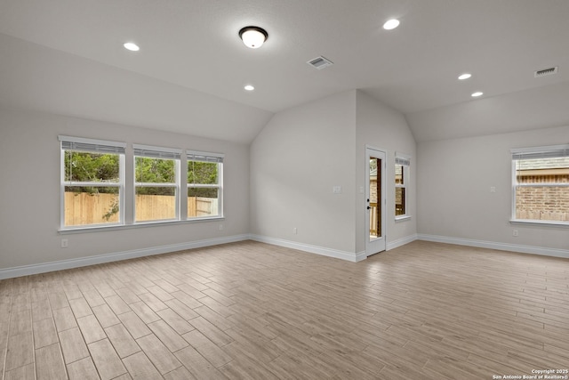 unfurnished living room featuring lofted ceiling