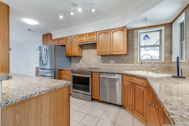 kitchen featuring decorative light fixtures, sink, light tile patterned floors, stainless steel appliances, and light stone countertops