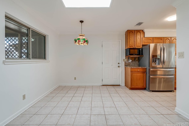 kitchen featuring a skylight, hanging light fixtures, ornamental molding, light tile patterned floors, and stainless steel refrigerator with ice dispenser