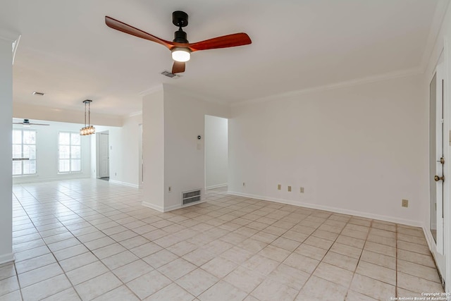 tiled empty room featuring ornamental molding and ceiling fan