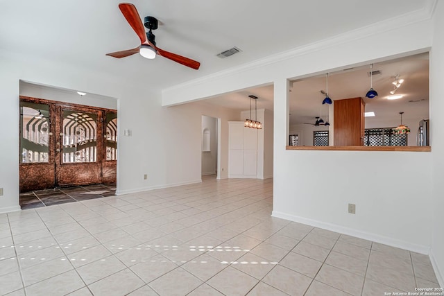 tiled spare room with ornamental molding and ceiling fan