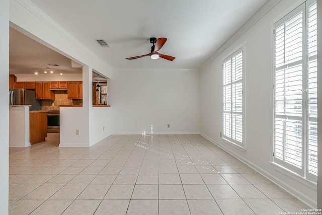 unfurnished living room with ceiling fan, ornamental molding, and light tile patterned floors