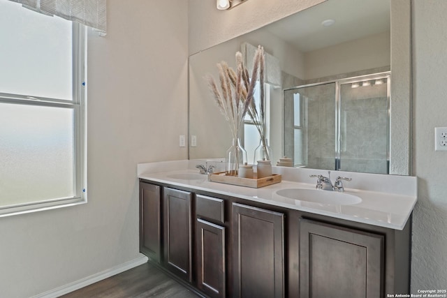 bathroom with vanity, an enclosed shower, and wood-type flooring