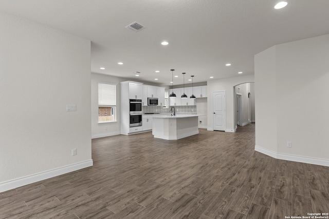 unfurnished living room with sink and dark hardwood / wood-style flooring