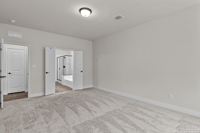 unfurnished bedroom featuring light colored carpet