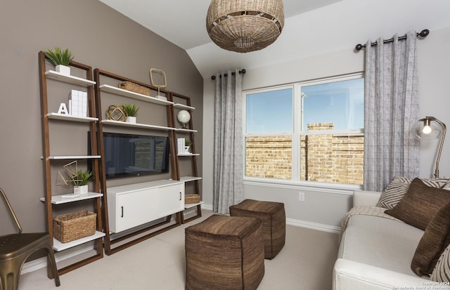 living room with lofted ceiling and carpet flooring