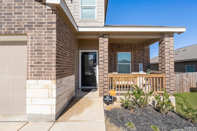 view of exterior entry with covered porch