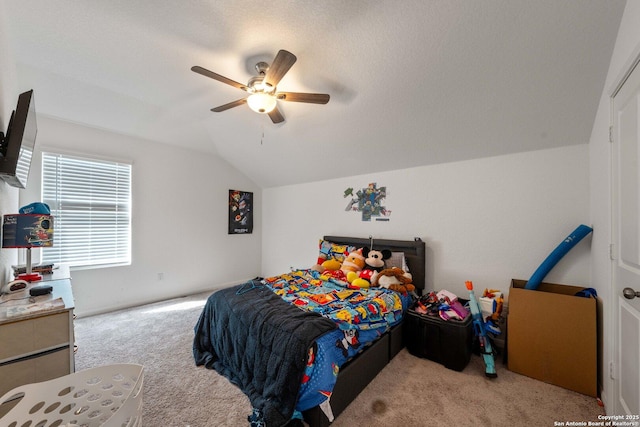 carpeted bedroom featuring lofted ceiling, a textured ceiling, and ceiling fan