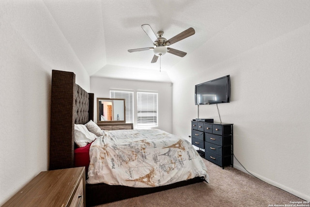 bedroom featuring ceiling fan, vaulted ceiling, and carpet