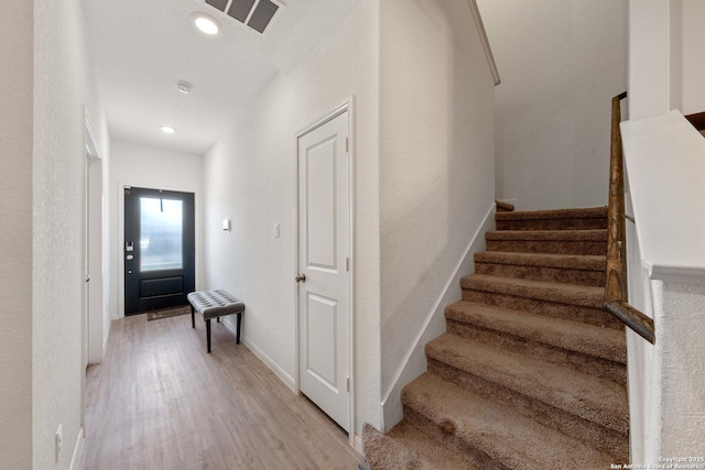 stairs with hardwood / wood-style floors