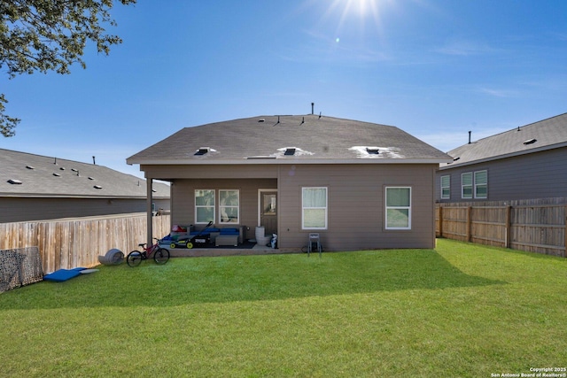 back of house with a lawn and a patio area