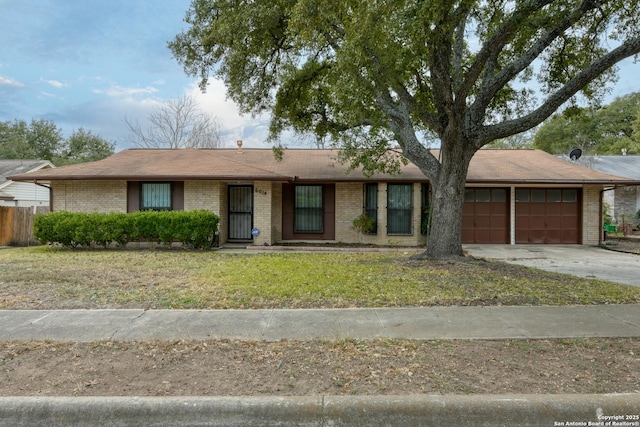 single story home with a garage and a front lawn