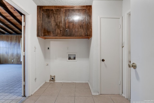 washroom with hookup for a washing machine, electric dryer hookup, cabinets, and hookup for a gas dryer