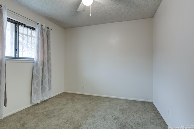 empty room featuring light carpet, ceiling fan, and a textured ceiling