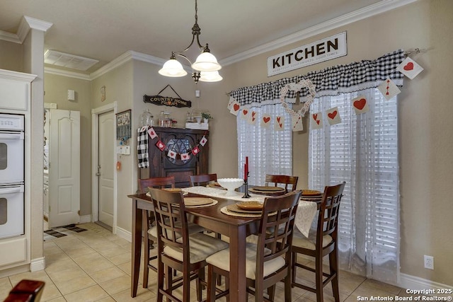 tiled dining room featuring crown molding and a chandelier