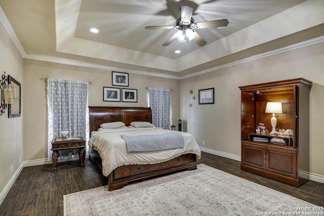 bedroom featuring a tray ceiling, ornamental molding, and ceiling fan