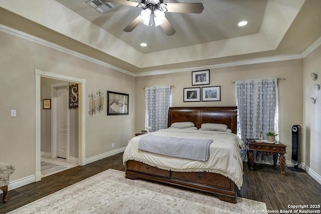 bedroom with crown molding, ceiling fan, and a raised ceiling