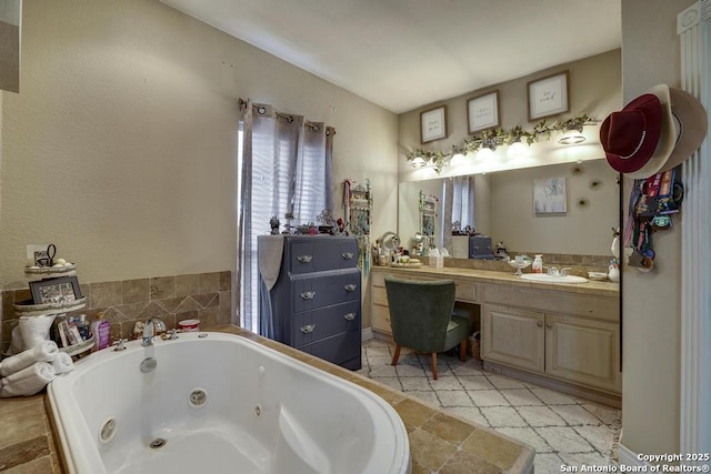 bathroom with vanity and tiled bath