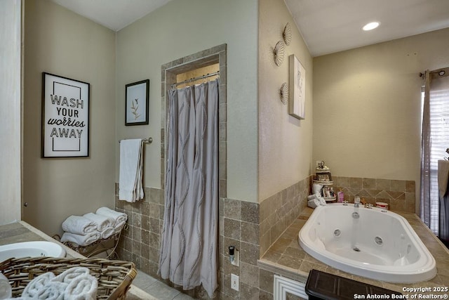 bathroom featuring tile walls and shower with separate bathtub