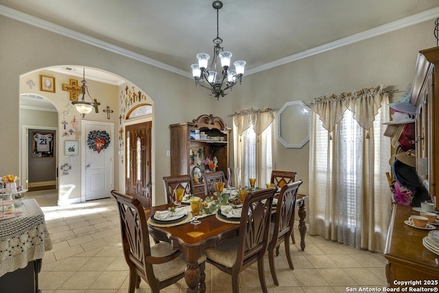 tiled dining area featuring crown molding and a notable chandelier