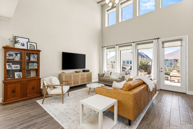 living room featuring a towering ceiling and ceiling fan