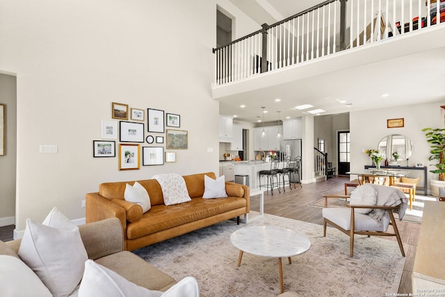 living room featuring a high ceiling and light wood-type flooring