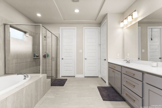 bathroom with tile patterned floors, vanity, and shower with separate bathtub