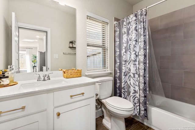 full bathroom featuring shower / bathtub combination with curtain, vanity, and toilet