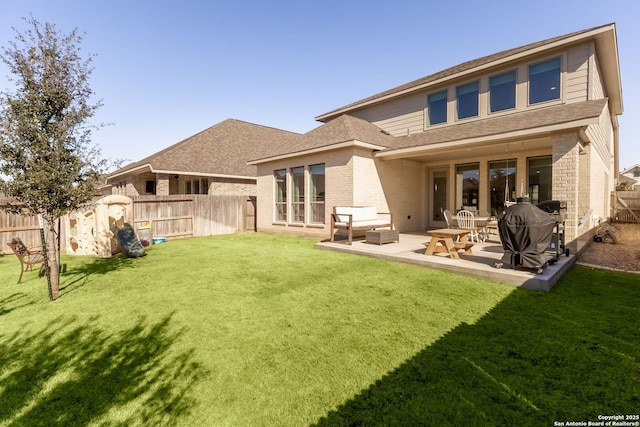 rear view of property with a yard and a patio