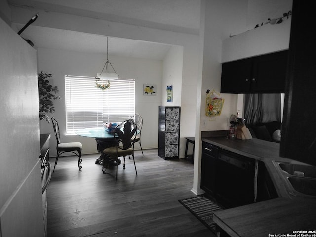 dining room with sink and dark wood-type flooring