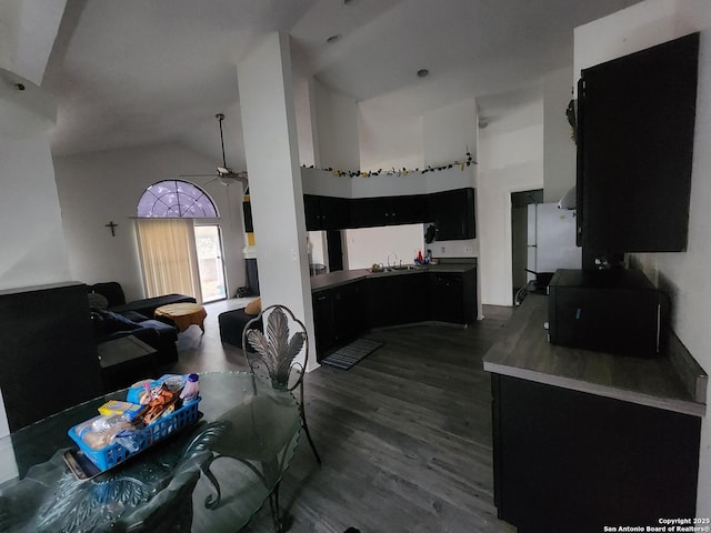 kitchen with high vaulted ceiling, dark hardwood / wood-style floors, white fridge, and ceiling fan