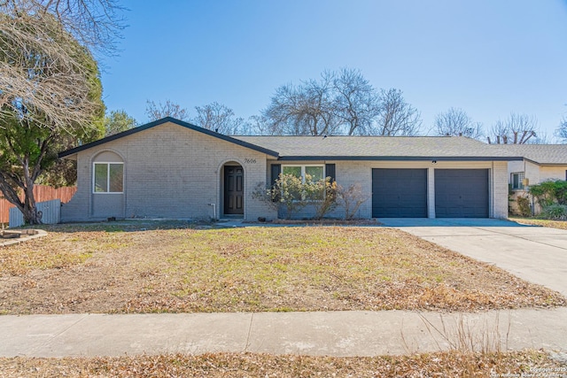 single story home featuring a garage and a front lawn