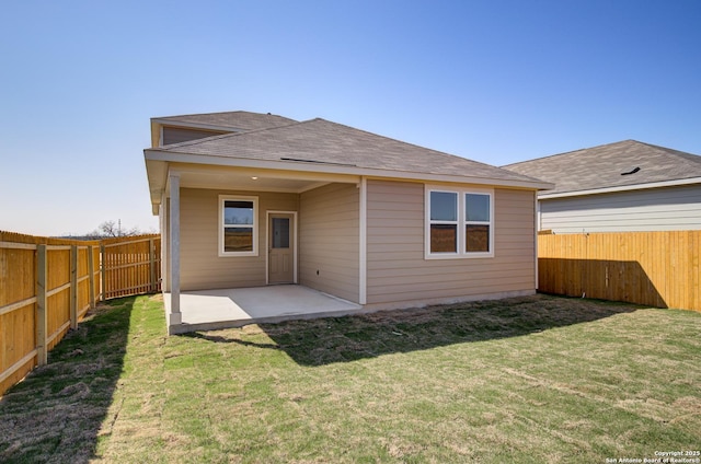back of property featuring a fenced backyard, a lawn, and a patio