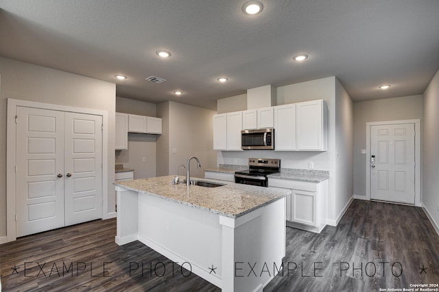 kitchen featuring a kitchen island with sink, sink, white cabinetry, and stainless steel appliances