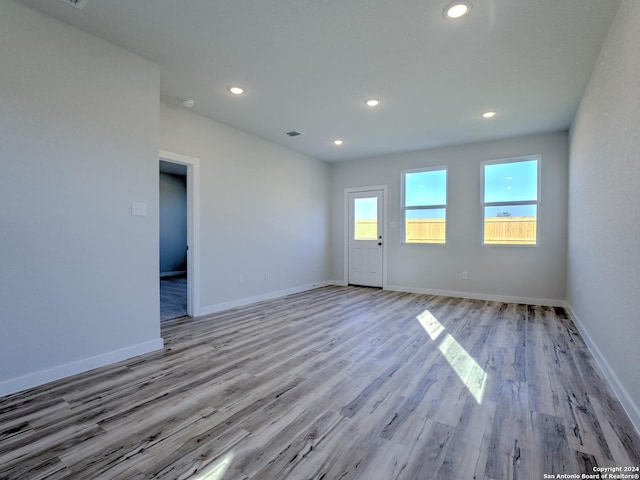 spare room with light hardwood / wood-style flooring