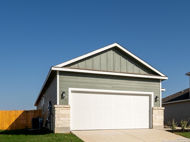 view of front of home with cooling unit and a garage