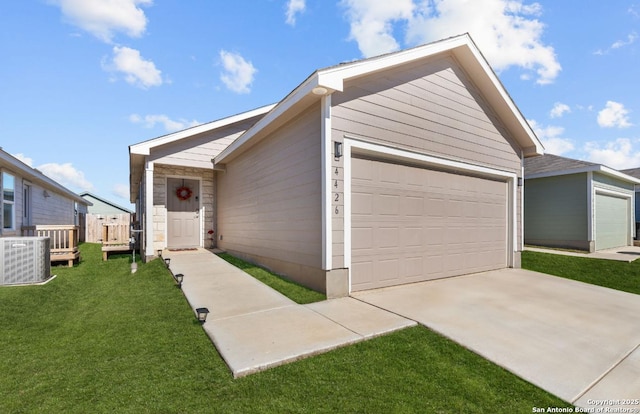 ranch-style house featuring a garage, central AC unit, and a front yard