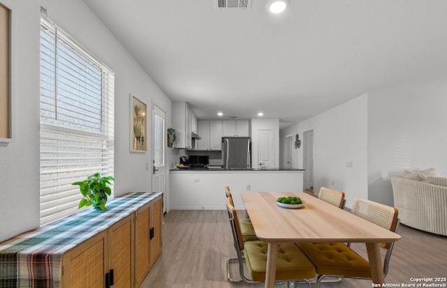 dining room with light wood-type flooring