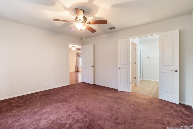 unfurnished bedroom featuring dark carpet and ceiling fan