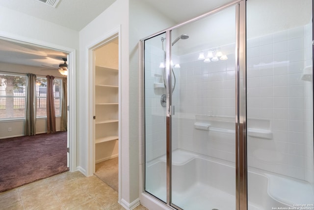 bathroom with walk in shower, ceiling fan, and tile patterned floors