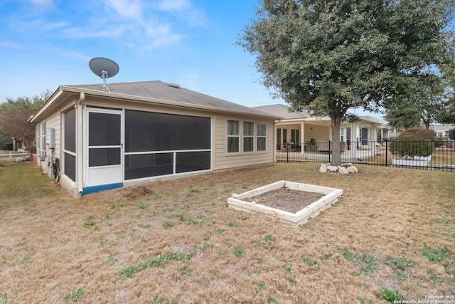 back of property featuring a yard and a sunroom