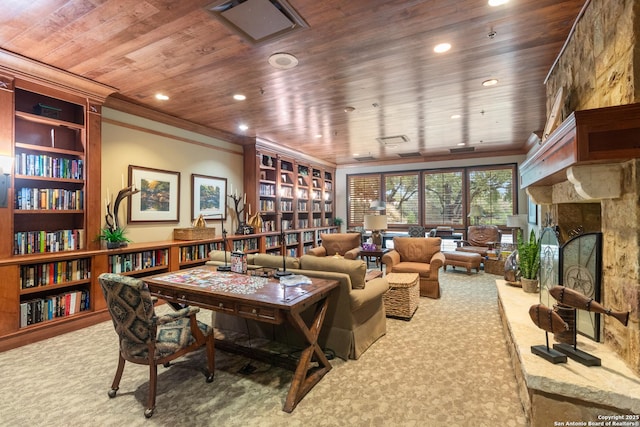 sitting room featuring wood ceiling, a stone fireplace, ornamental molding, and carpet flooring