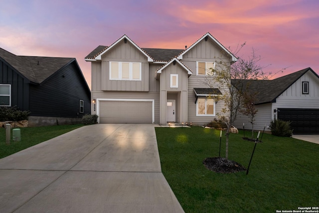 view of front of property featuring a garage and a lawn