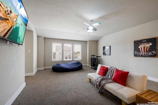 carpeted bedroom with ceiling fan and a textured ceiling