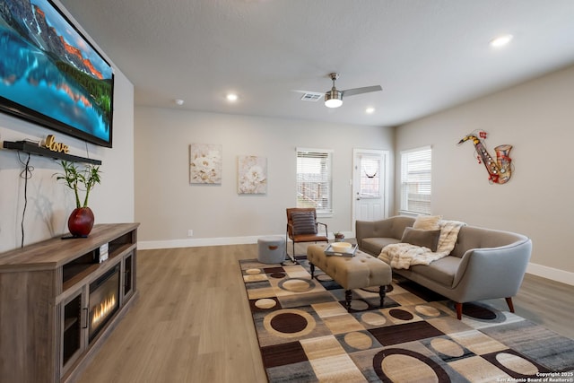 living room with hardwood / wood-style flooring and ceiling fan