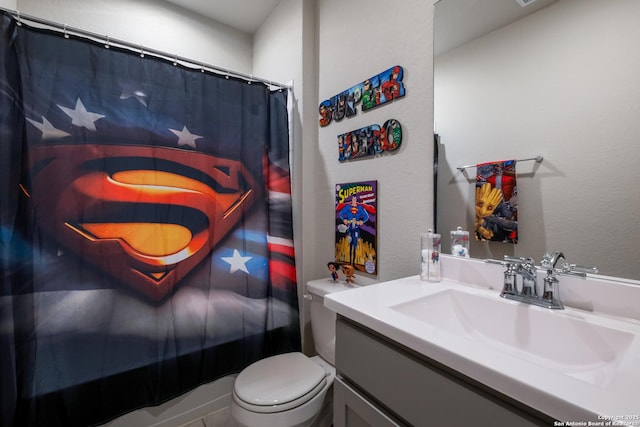 bathroom featuring vanity, toilet, and a shower with shower curtain